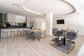 A modern interior with a kitchen, dining area, and seating space. - INf36K - Luxury apartment perfect location (Estepona)