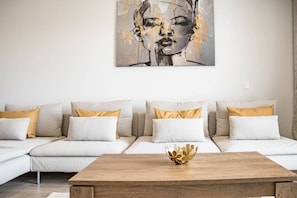 A modern living room with a sofa set, a coffee table, and a wall-mounted artwork. - Apartment with 3BR, garden, pool & gym - JG5. 4A (Marbella)