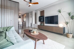 A modern living room with a sofa, coffee table, and a TV mounted on the wall. - Jm94 - Totally renovated in stylish design (Mijas)