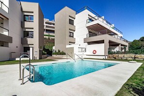 A modern residential building with a swimming pool, balconies, and a stone retaining wall. - ML2B1- Stunning holiday home in Marbella (Marbella)
