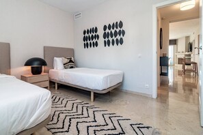 A modern bedroom with a bed, bedside table, lamp, and decorative wall art. - MA7B-Stunning holiday home top location (Marbella)