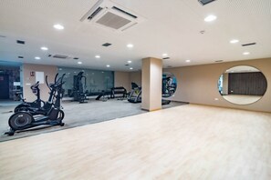 A gym with cardio machines, free weights, and a mirrored wall. - Estepona Penthouse, Hot Tub, Views Oasis325 (Málaga)