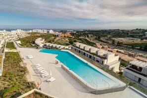 A swimming pool with sun loungers and a view of the surrounding buildings. - OV - Stunning flat in resort (Estepona)