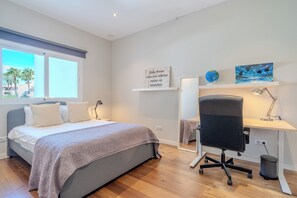 A bedroom with a bed, a desk, a chair, a globe, and a painting on the wall. - RG133 - Spacious 3 bed apartment in prime location (Marbella)