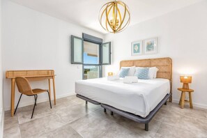 A bedroom with a bed, a desk, a chair, a bedside table, and a lamp. - SB311G - Modern & well connected 2 bed apartment (Estepona)