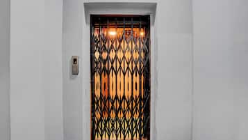 A door with a metal gate and a digital lock.