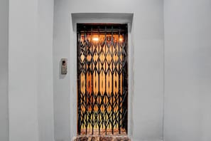 A door with a metal gate and a digital lock. - Hotel O Vijayawada Bus Terminal (Vijayawada)