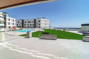 A rooftop pool area with a clear view of the sea, surrounded by modern buildings. - VV6-2B - Modern 2BR with large seaview balcony (Estepona)