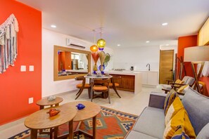 A compact living space with a dining area, kitchenette, and seating area. - Cozy Modern Condo Steps to Everything (Puerto Vallarta)