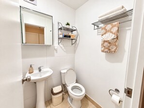A bathroom with a toilet, sink, and a towel rack with a patterned towel. - North Lima Skyline -24th floor Panoramic view (Independencia)