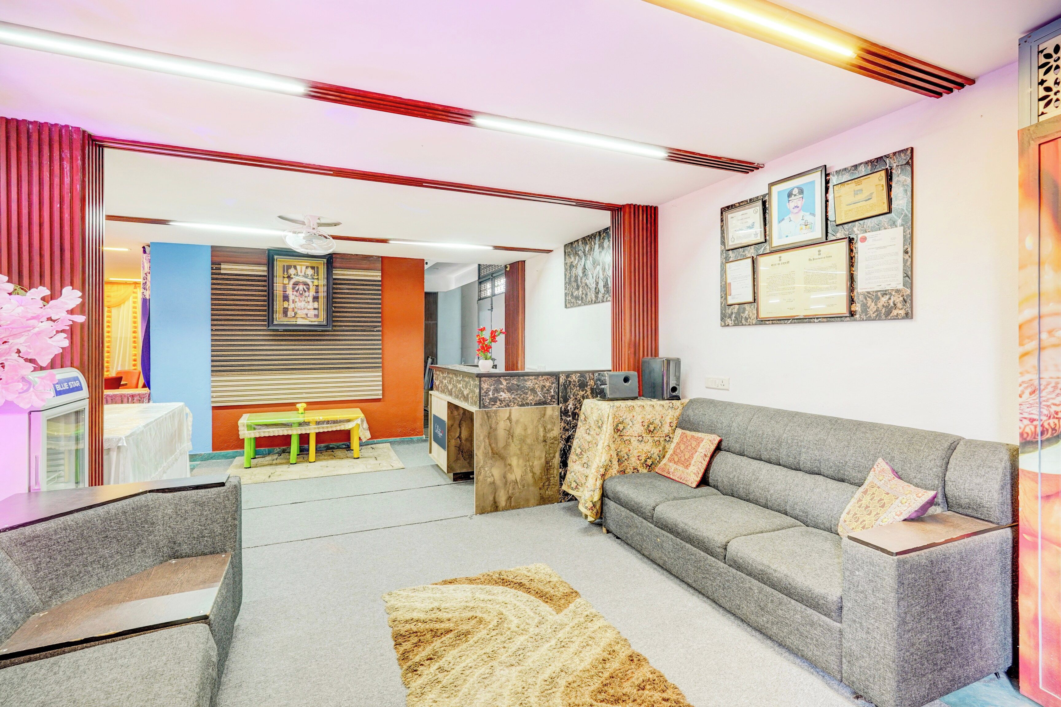A modern living room with a grey sofa, a small table, and a decorative rug.