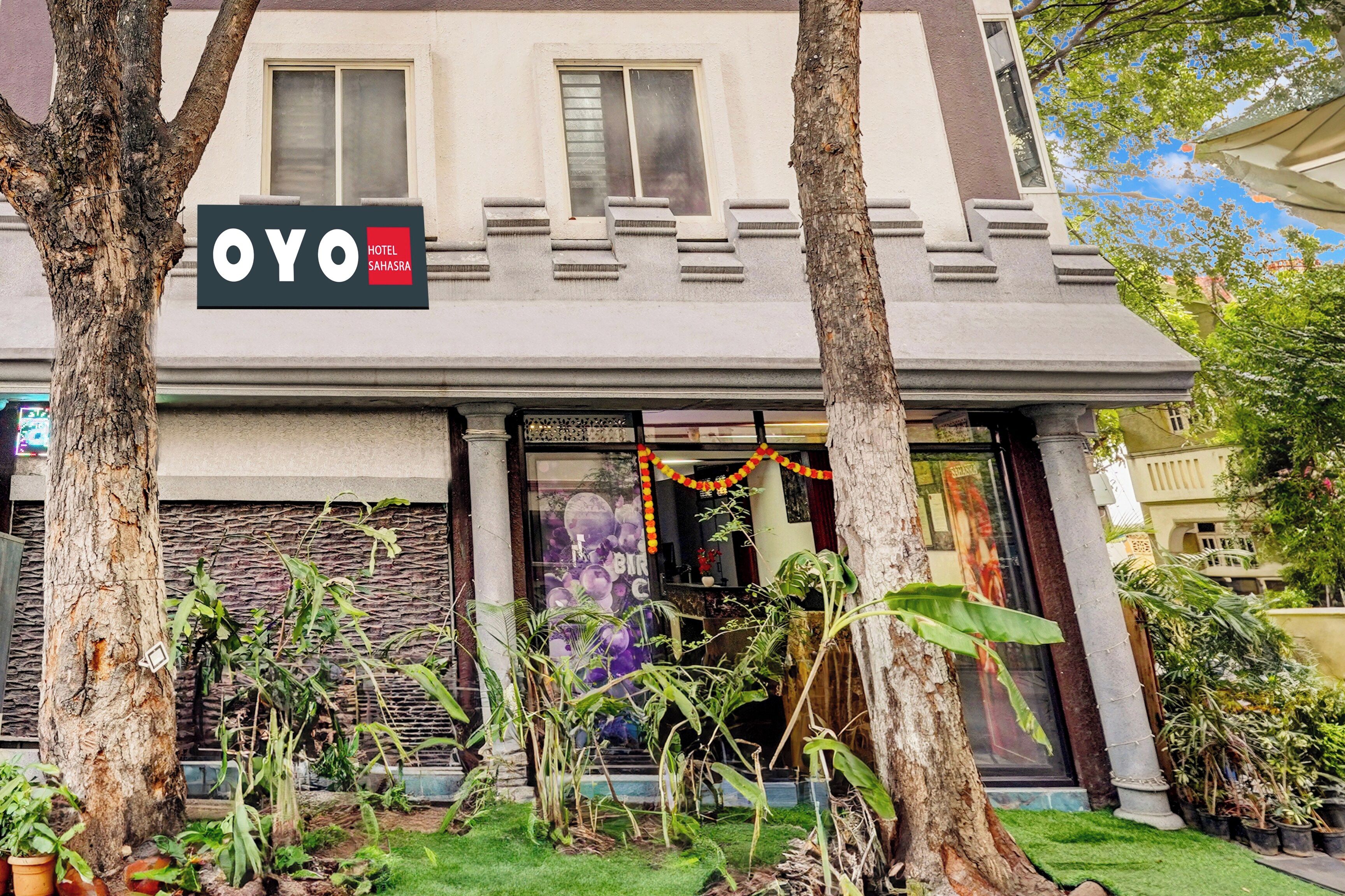 A hotel entrance with a sign reading 'OYO HOTEL SAHASRA'.