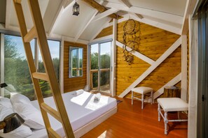 A bedroom with a loft bed, a window, a dreamcatcher, and a wooden floor. - Country House 'Terra Vine Collection - Dream' with Wi-Fi and Air Conditioning (Αρκάδιοι)