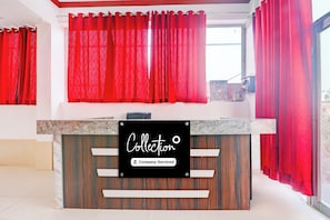 A reception desk with a sign indicating it's company-serviced. - Collection O Ayodhya Near Airport (Faizabad)