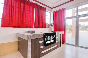 A reception desk with a sign that reads 'Collection Company-Serviced'. - Collection O Ayodhya Near Airport (Ayodhya)