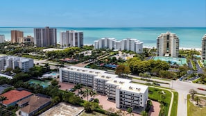 A coastal urban area with high-rise buildings, a road, and a beach. - Grandview 2BR | Walk to Beach & Marco Walk (Marco Island)