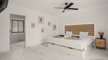 Un dormitorio con cama, ventilador de techo, cabecera de madera, mesita de noche y ventana con celosía decorativa.