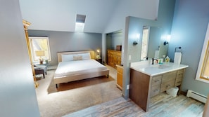 A modern bedroom with a large bed, a vanity with a mirror, and a dresser. - Private Hot Tub, Pet Friendly in Frisco. Spacious Townhouse, Garage, Grill (Frisco)