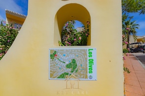 A building with a map sign labeled 'Los Olivos' and a KEY CARE logo. - Seraphim  | Luxury 3-Bed Penthouse at La Manga Club (Atamaria)