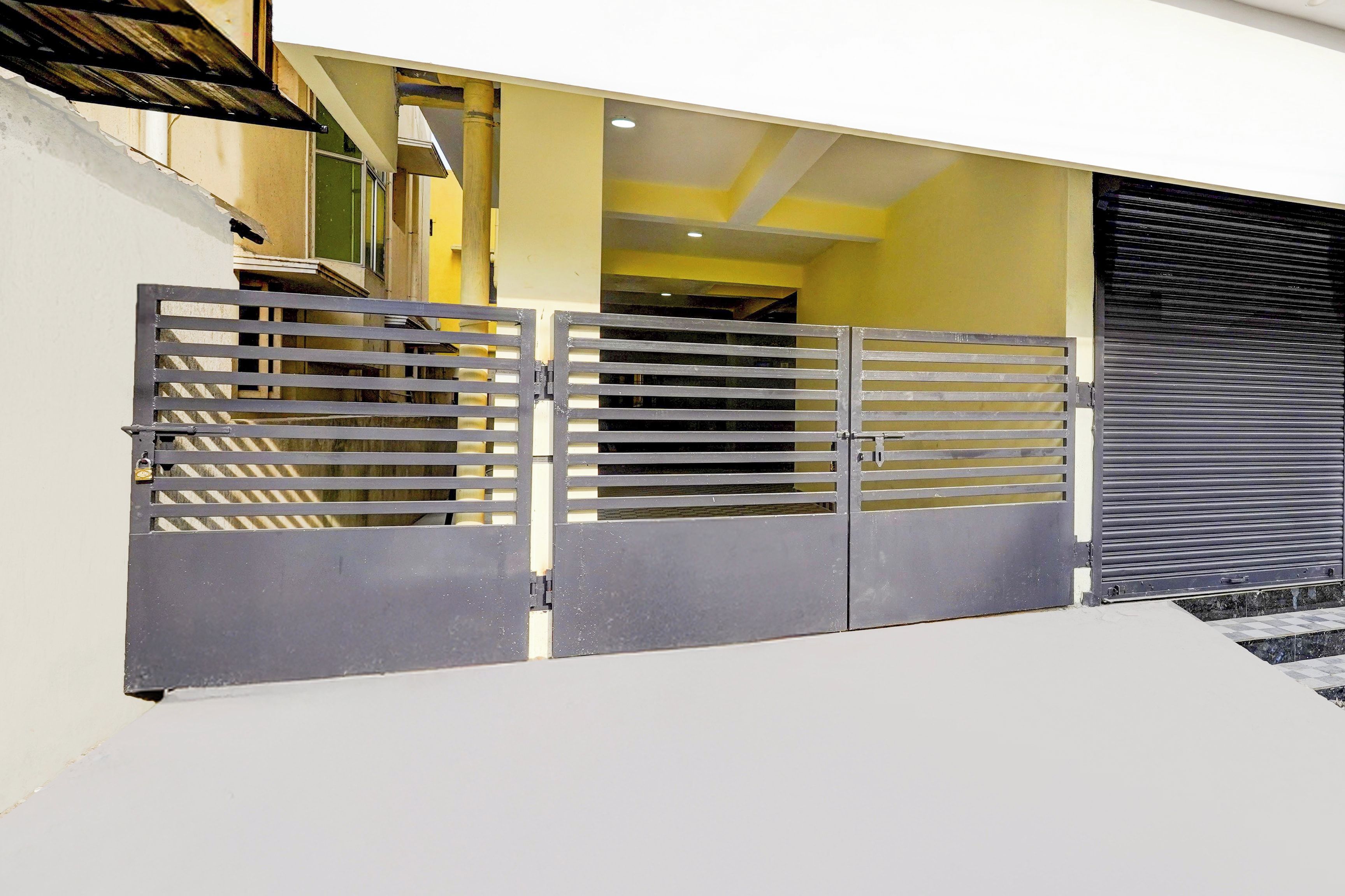 A gated entrance with a metal gate and a sliding door.