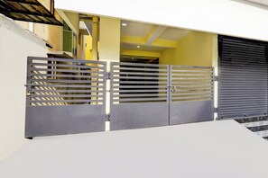 A gated entrance with a metal gate and a sliding door.