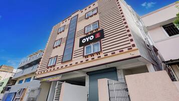 A multi-story building with a sign indicating 'OYO' and 'Eswar Grand Palace'.