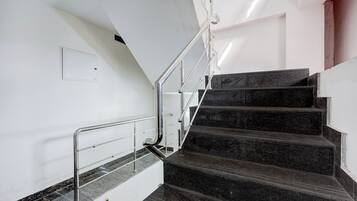 A staircase with metal railings and marble steps.
