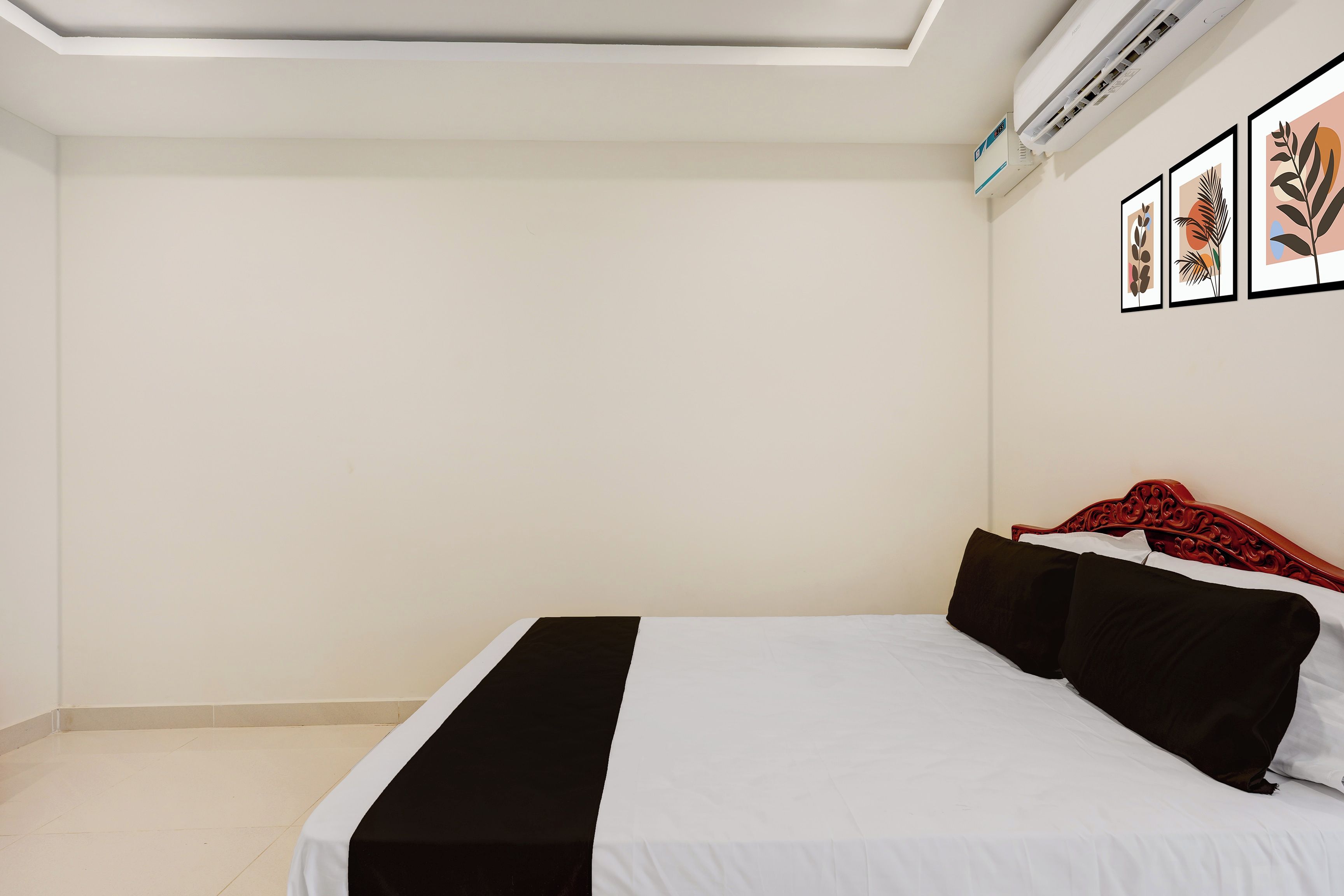 A bedroom with a bed, a ceiling fan, and wall-mounted air conditioning unit.