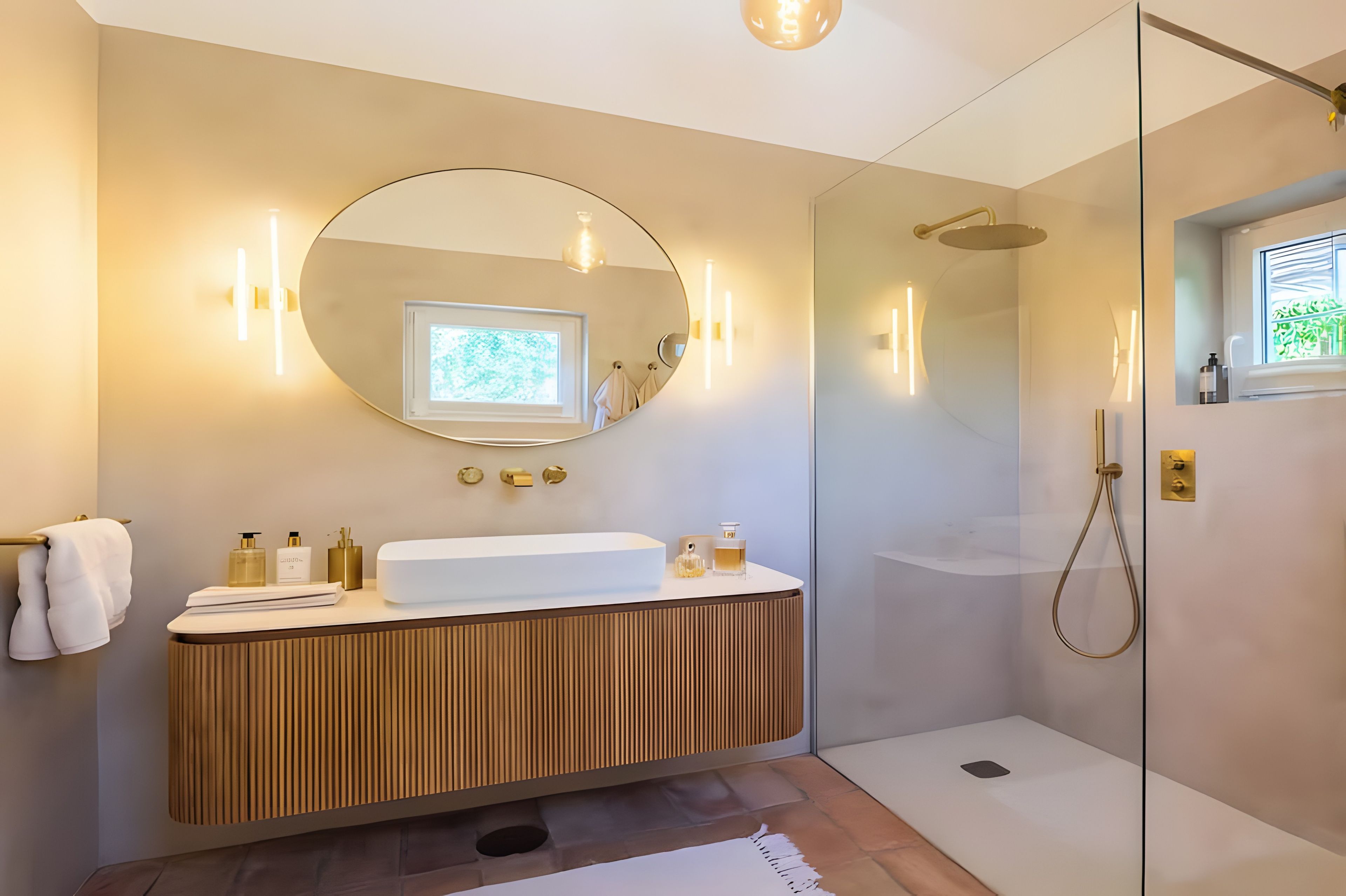 A modern bathroom with a wooden vanity, a large mirror, and a glass-enclosed shower.