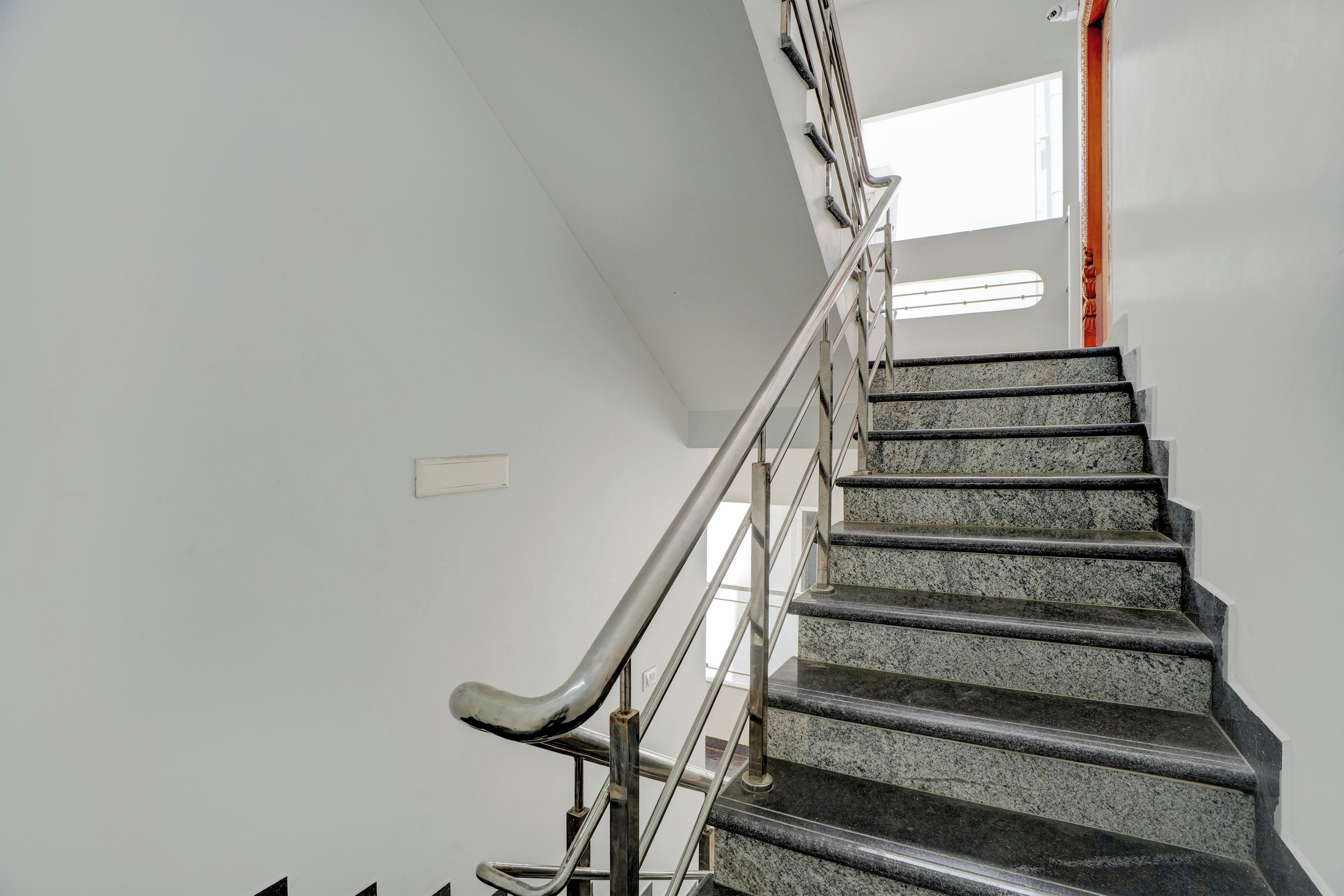 A staircase with metal handrails and granite steps.