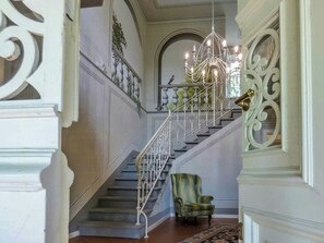 A grand staircase with ornate metal railings and a chandelier, leading to an upper floor. - Historic villa with pool and tennis near Lucca (San Ginese)