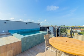 A rooftop pool area with a clear view of the cityscape. - Cais Eco #311 - Cobertura Com Piscina by Carpediem (Ipojuca)