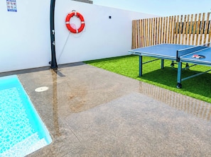 A pool table with a life preserver on a wall, a small pool, and a wooden fence. - Casa Drago Uno - Three Bedroom Villa, Sleeps 5 (Caleta de Fustes)