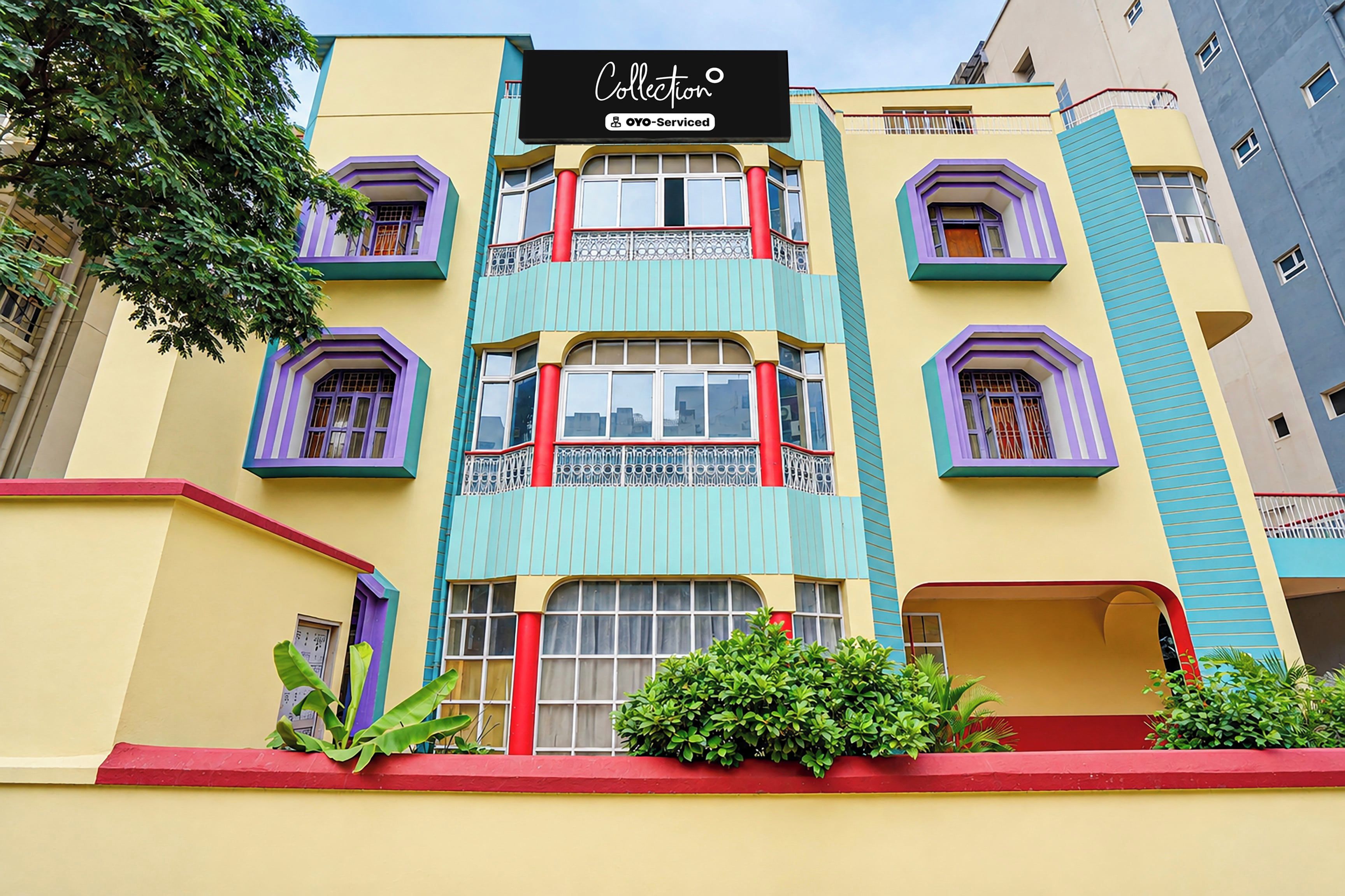 A colorful building with a sign that reads 'Collection OYO-Serviced.'