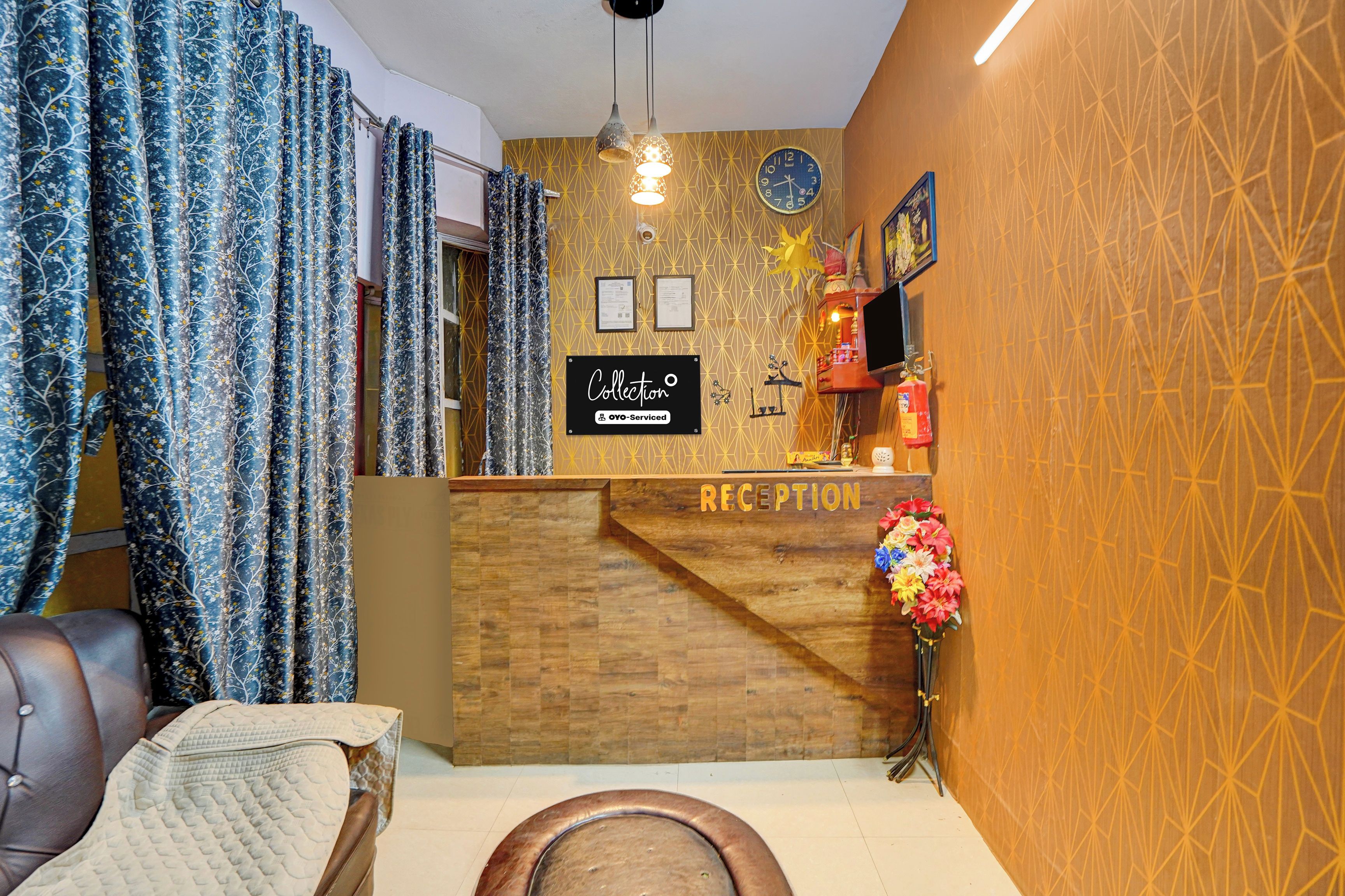 A reception area with a wooden desk, a clock, framed certificates, and a fire extinguisher.
