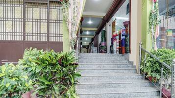 A staircase leading to a shop with colorful items on display.