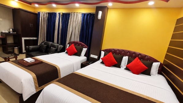 A hotel room with two beds, a sofa, a desk, and a television. - Hotel O Jessore Road Kolkata Airport (Kolkata)