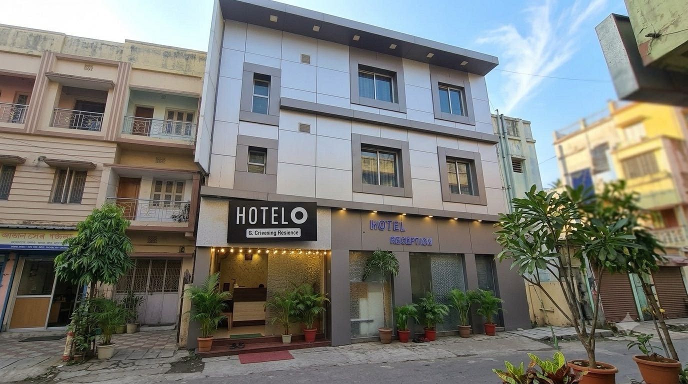 A hotel with a reception area, multiple floors, and potted plants in front.