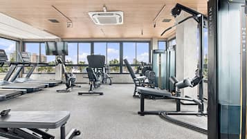 A gym with treadmills, exercise bikes, and weight machines.