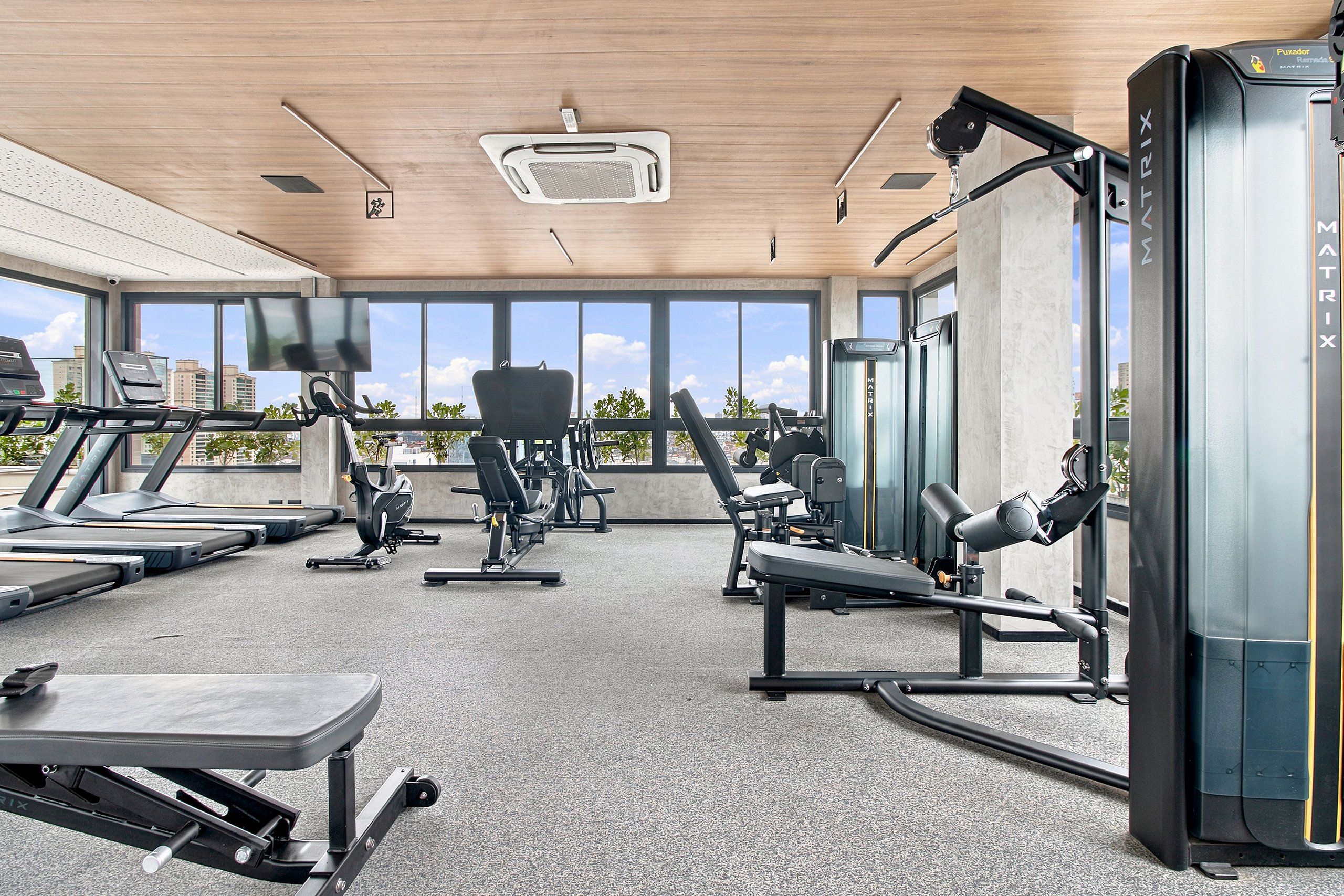 A gym with treadmills, exercise bikes, and weight machines.