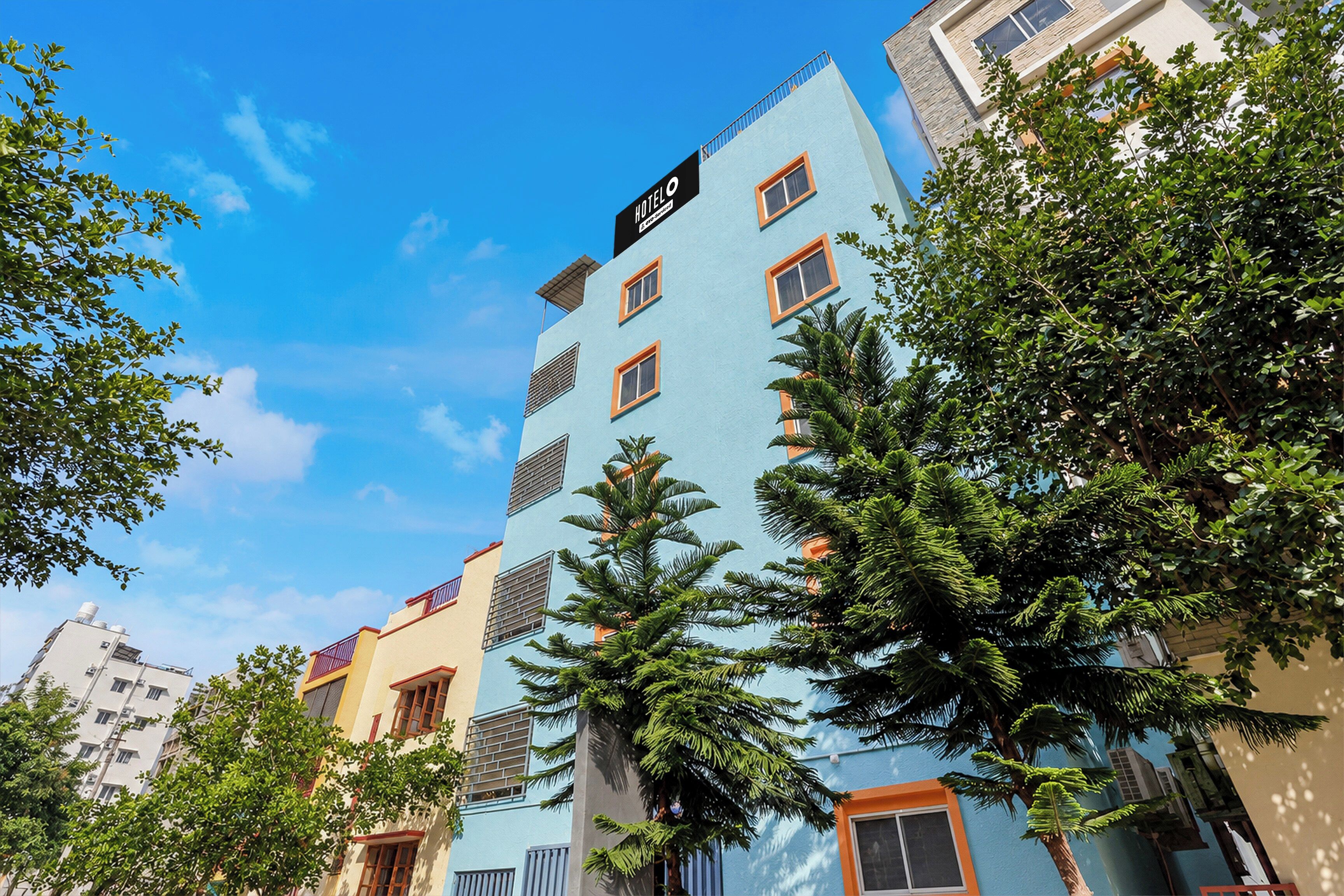 A multi-story hotel building with a sign indicating it is a hotel.
