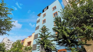 A multi-story hotel building with a sign indicating it is a hotel.