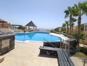A swimming pool with a stone deck, a gazebo, and palm trees. - 2 Bed House Dream Sea Views (CN)