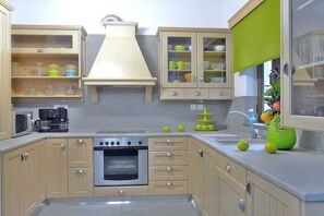 A kitchen with a stove, oven, cabinets, and a sink. - Peaceful Pool Villa in Crete Countryside (Crete)