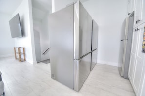 Sleek, modern kitchen space with stainless steel appliances and pristine white finishes awaits your culinary adventures. - Ocean Views • Private Pool and Spa • 12 Sleeping Rooms • Sleeps 28 (North Myrtle Beach)