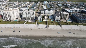 A coastal residential area with beachfront properties, a boardwalk, and a water tower. - Ocean Views • Private Pool and Spa • 12 Sleeping Rooms • Sleeps 28 (North Myrtle Beach)