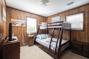 A bunk bed room with wooden walls, a desk with a computer, and two windows with blinds. - Coastal Charm w/ just 4min Walk to Beach (Kitty Hawk)