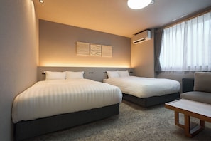 A hotel room with two beds, a small table, and a window with curtains. - HOTEL SOVA Kumamoto Keitokubori-machi (Kumamoto)
