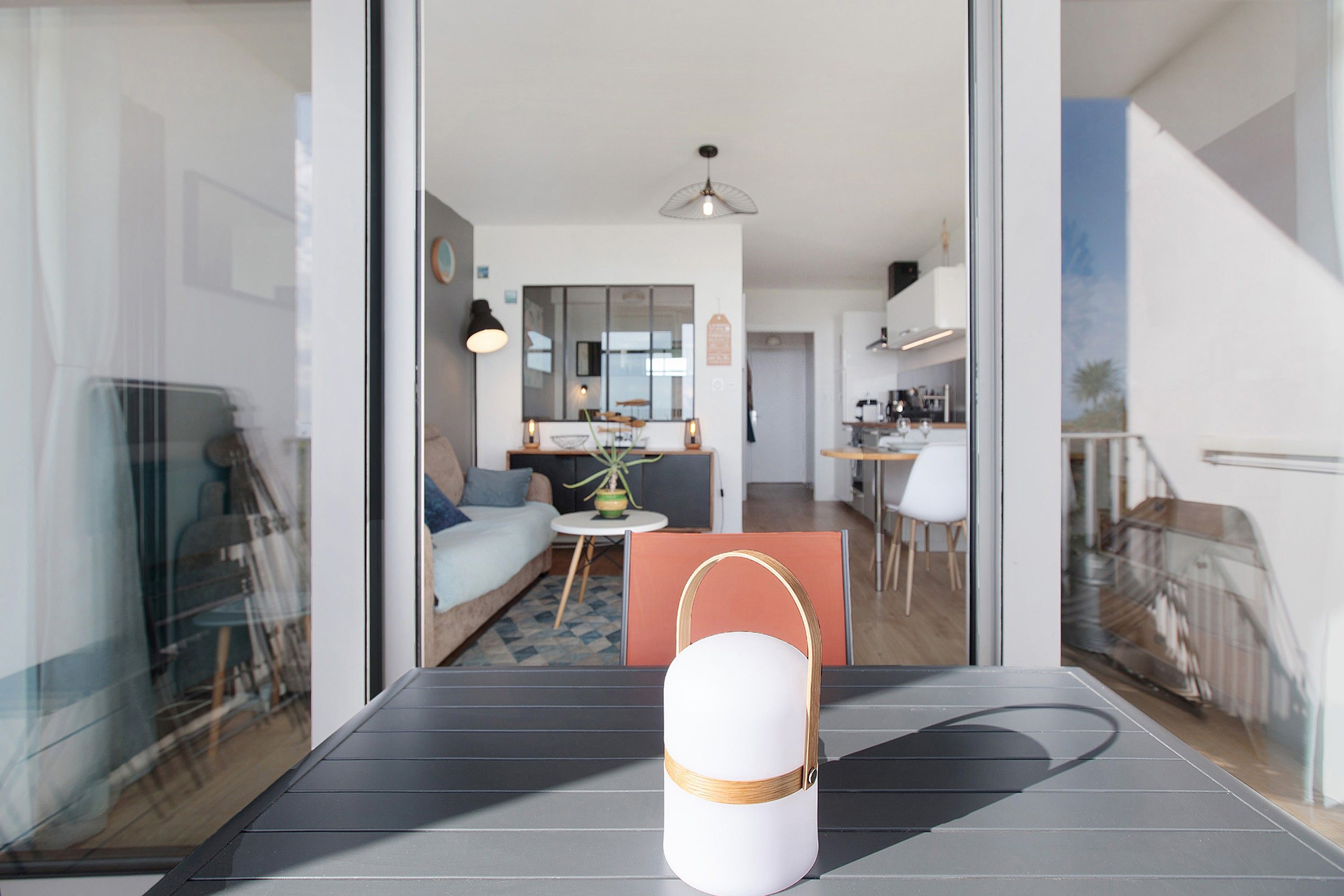 Un espacio habitable moderno con comedor, cocina y vistas a través de un ventanal.