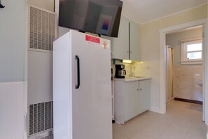 A compact kitchen with a white refrigerator, a coffee maker, and a microwave. - Beach Access! Sunrise Side Resort Retreat (Greenbush)